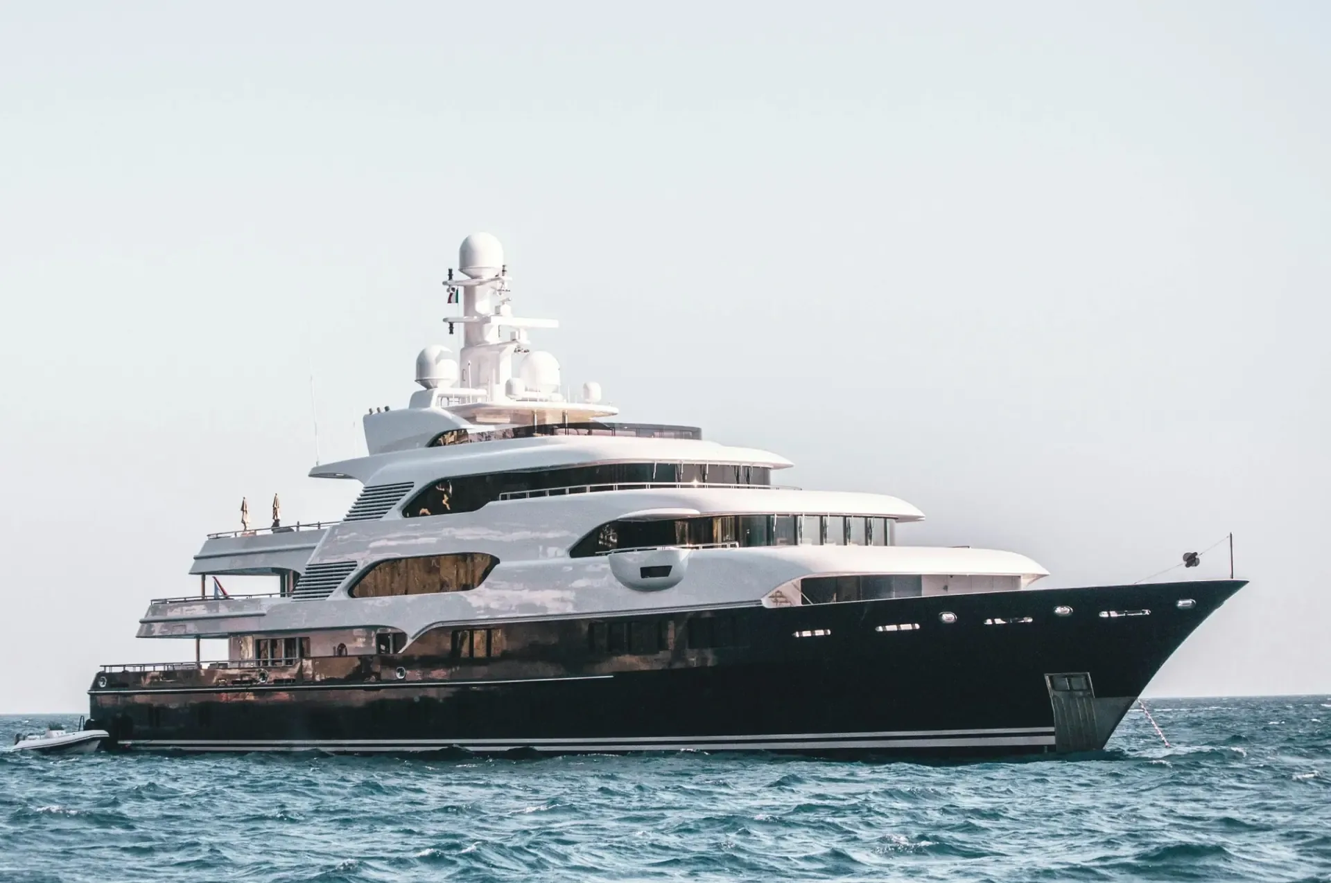 A limited-production superyacht at anchor on open water