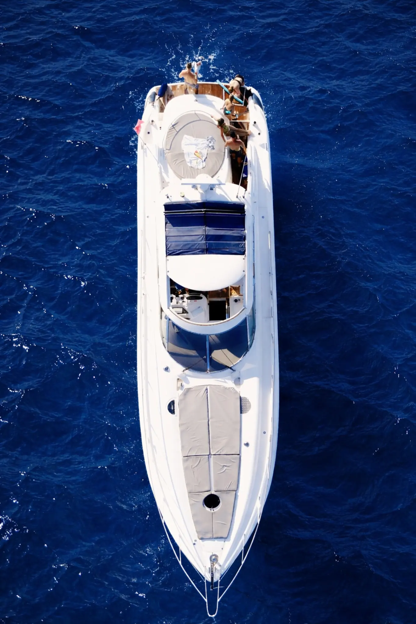 An aerial view of a charter motor yacht on open water