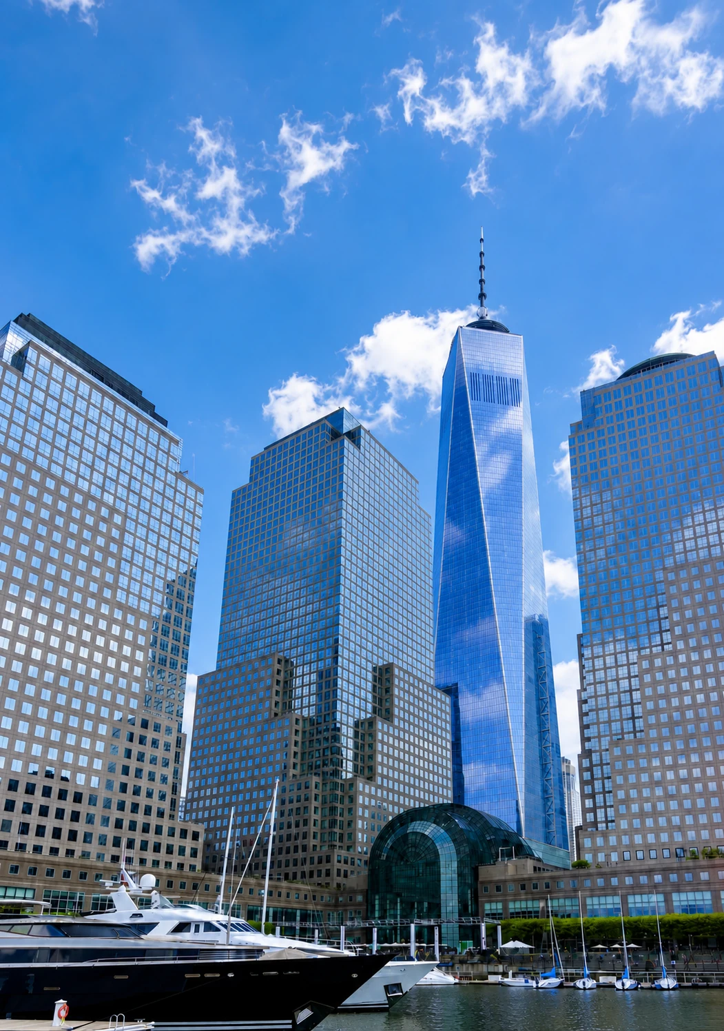 A yacht on the water below the Lower Manhattan skyline